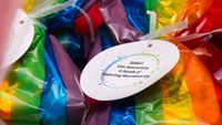 rainbow background with white paper circle on it that reads, 