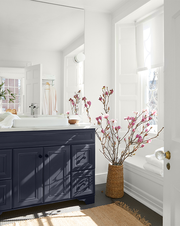 A white painted bathroom with a black vanity.