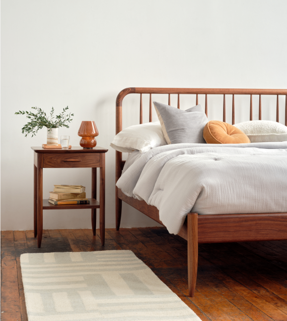 The Bates Bed and Side Table in walnut.