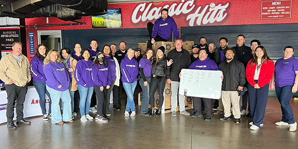 Angels and Discount Tire Employees Pack Meals for Kids Around the World