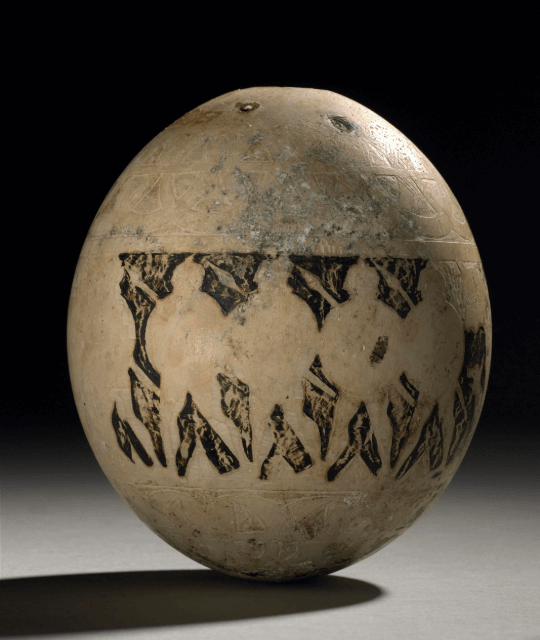 Ostrich egg with warriors engraved on the shell.
