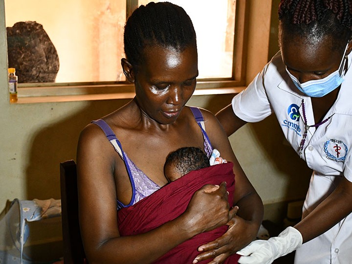 Image description: Atim, a mother in South Sudan, with her infant
