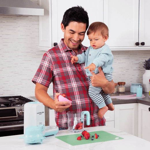 Dad holding baby blending