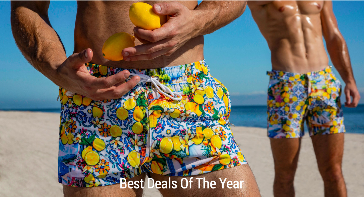 DC2 Miami — models wearing Citrics Choice Poolside Shorts on the beach, holding fresh lemons. The Amalfi-inspired citrus print.
