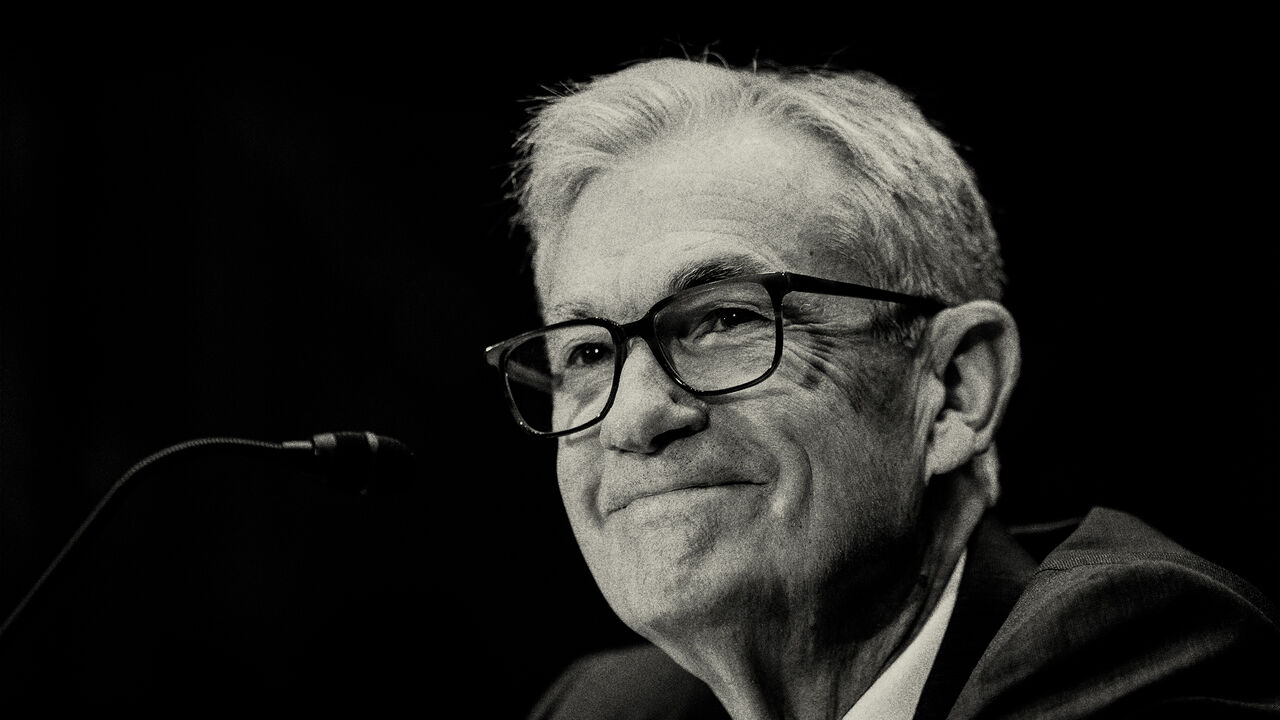 A black and white photo of Jerome Powell, Chair of the Federal Reserve of the United States, with a reserved smile.