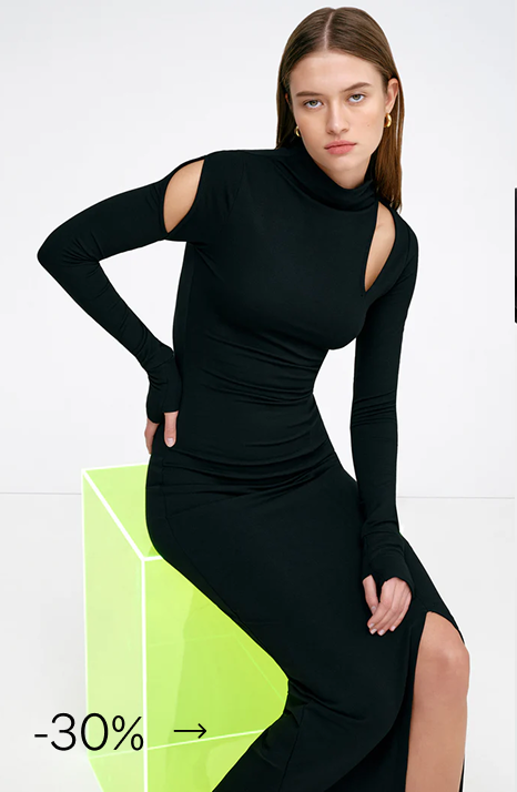 Bianca wearing The Park Mockneck Dress with shoulder cutouts and side slit.
