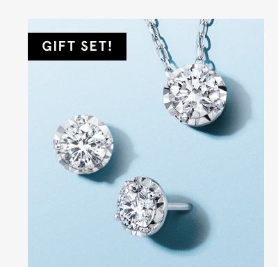 Gift set of white gold diamond pendant necklace and matching stud earrings.