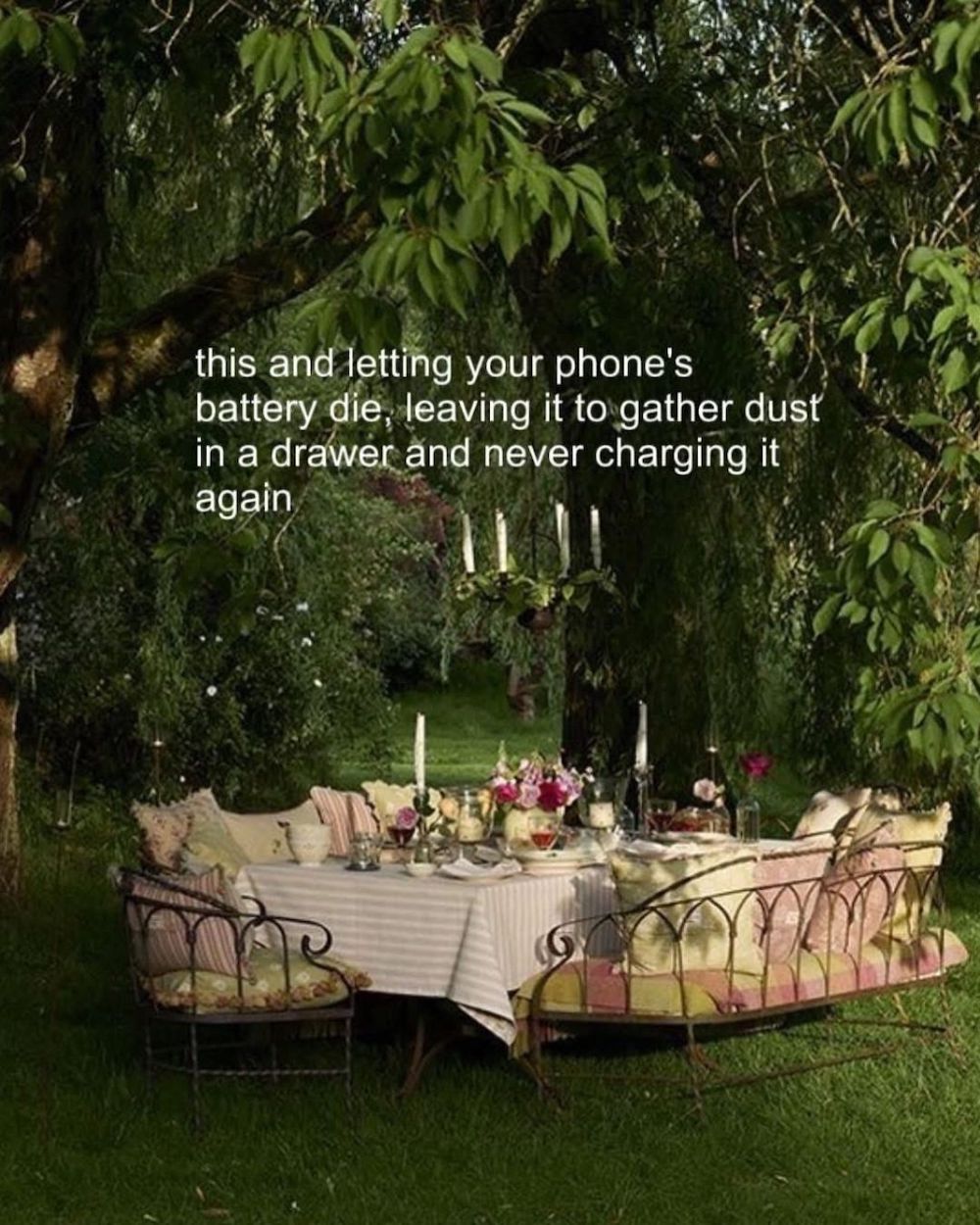 A table beneath lush trees is covered in a pink tablecloth and set for a party. Text above this says: this and letting your phone's battery die, leaving it to gather dust in a drawer and never charging it again.