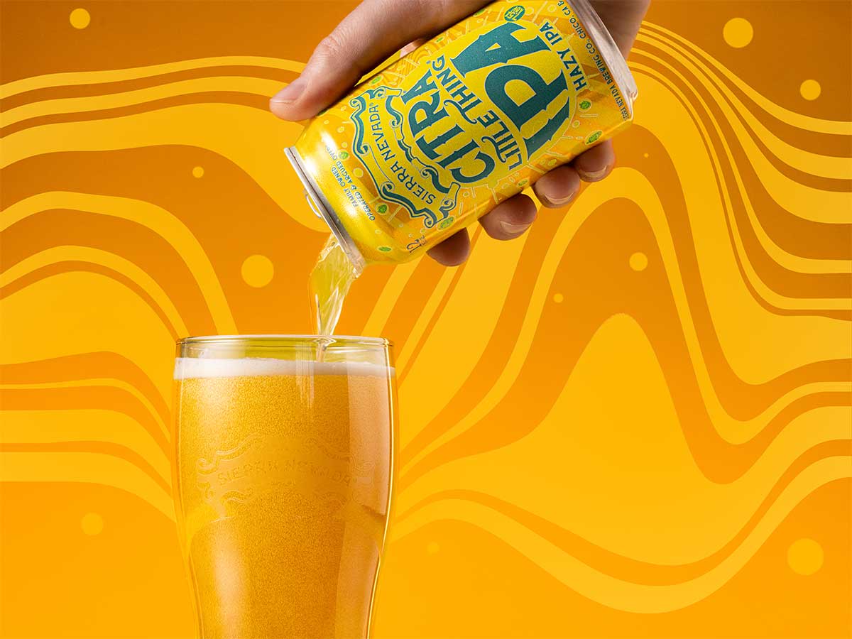 A hand pouring a can of Citra Little Thing into a glass