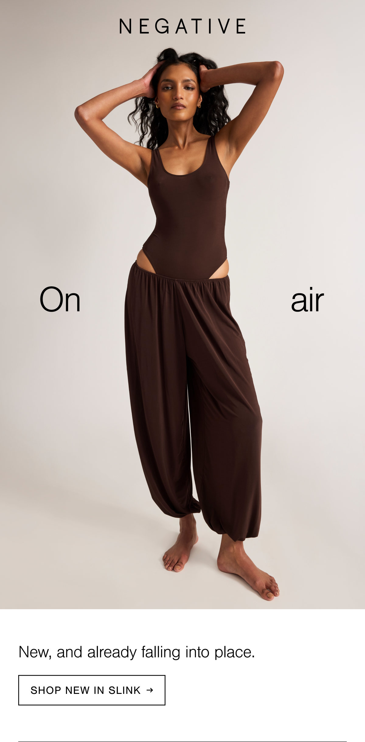 Model wearing the Slink Tank Bodysuit and Slink Draped Pant in Espresso. Shop New in Slink.