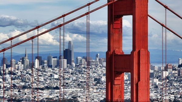 A view of Golden Gate Bridge in the foreground with the cityscape in the background in San Francisco, California, USA.