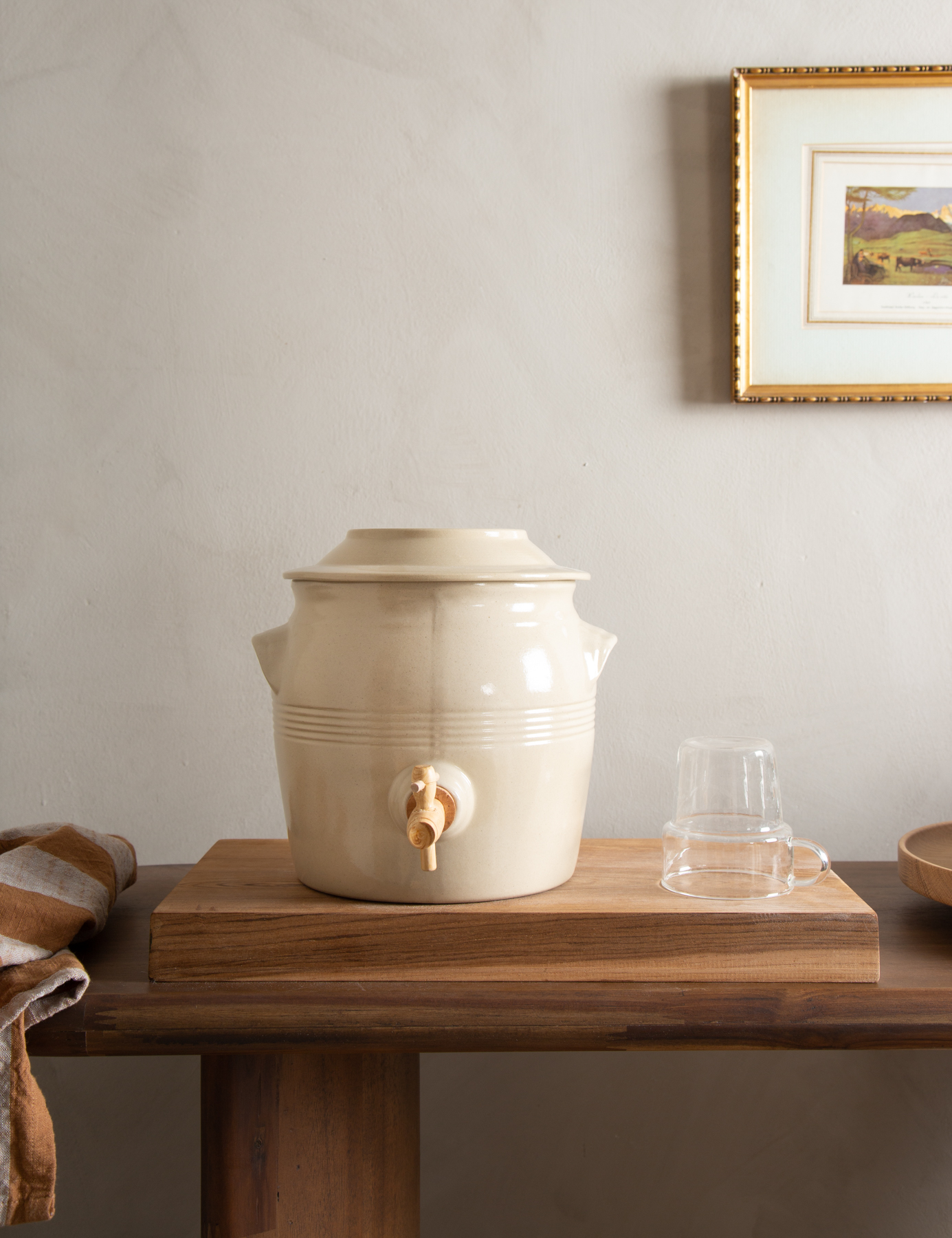 a brown wooden table with a water jar