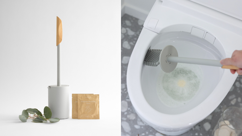 A minimal product shot of a white toilet brush and holder with a light wood handle, styled on a clean surface with green leaves and a packet of cleaning stones beside it. Next to it, a close-up action shot shows the silicone brush scrubbing inside a toilet bowl.