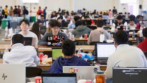 crowd of students working on laptops
