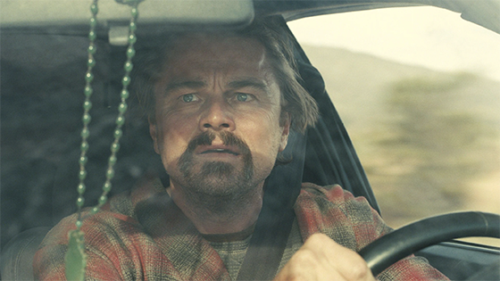 Leonardo diCaprio driving a car in a scenen from the movie.