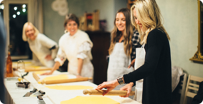 Women in a pasta-making class on London, Paris & Rome for Solo Women Travelers — opens itinerary