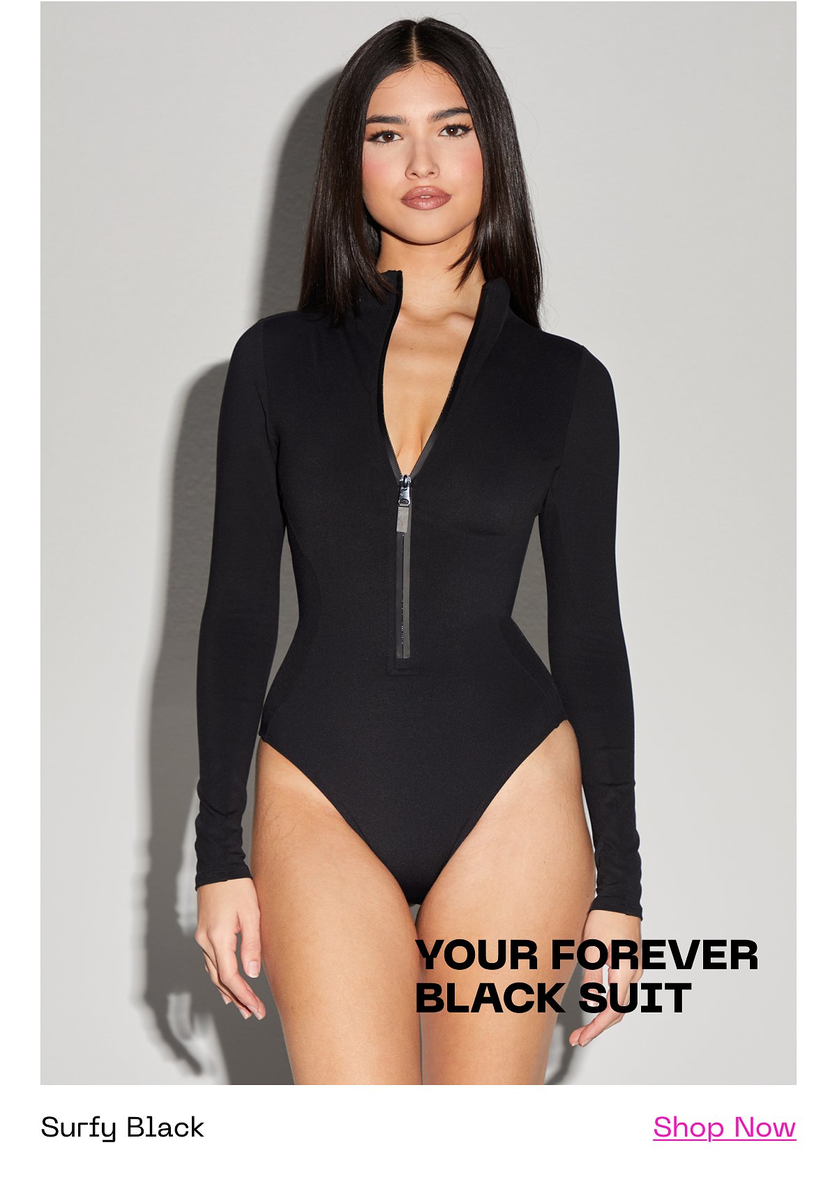 Model wearing a black long-sleeve swimsuit with a zipper.