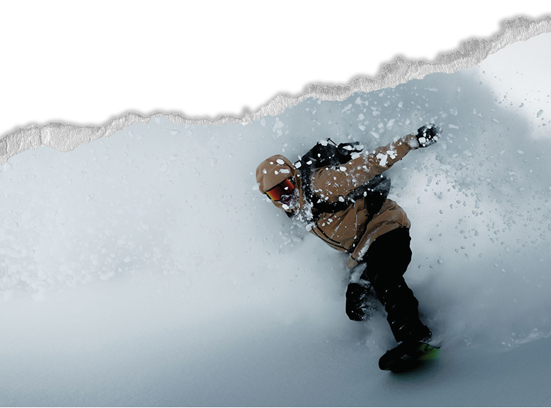A snowboarder shredding through fresh powder.