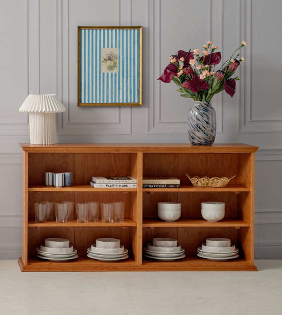 The Long Bookcase in cherry shown as a sideboard in a dining room.