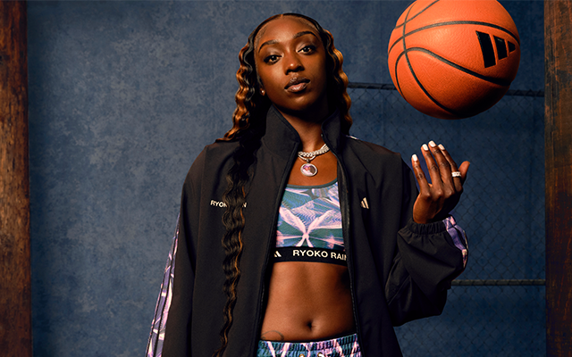Kahleah Copper holding a basketball styling the adidas Basketball x Ryoko Rain "Dear Daughter" collection inspired by transformation, heritage storytelling and the butterfly effect