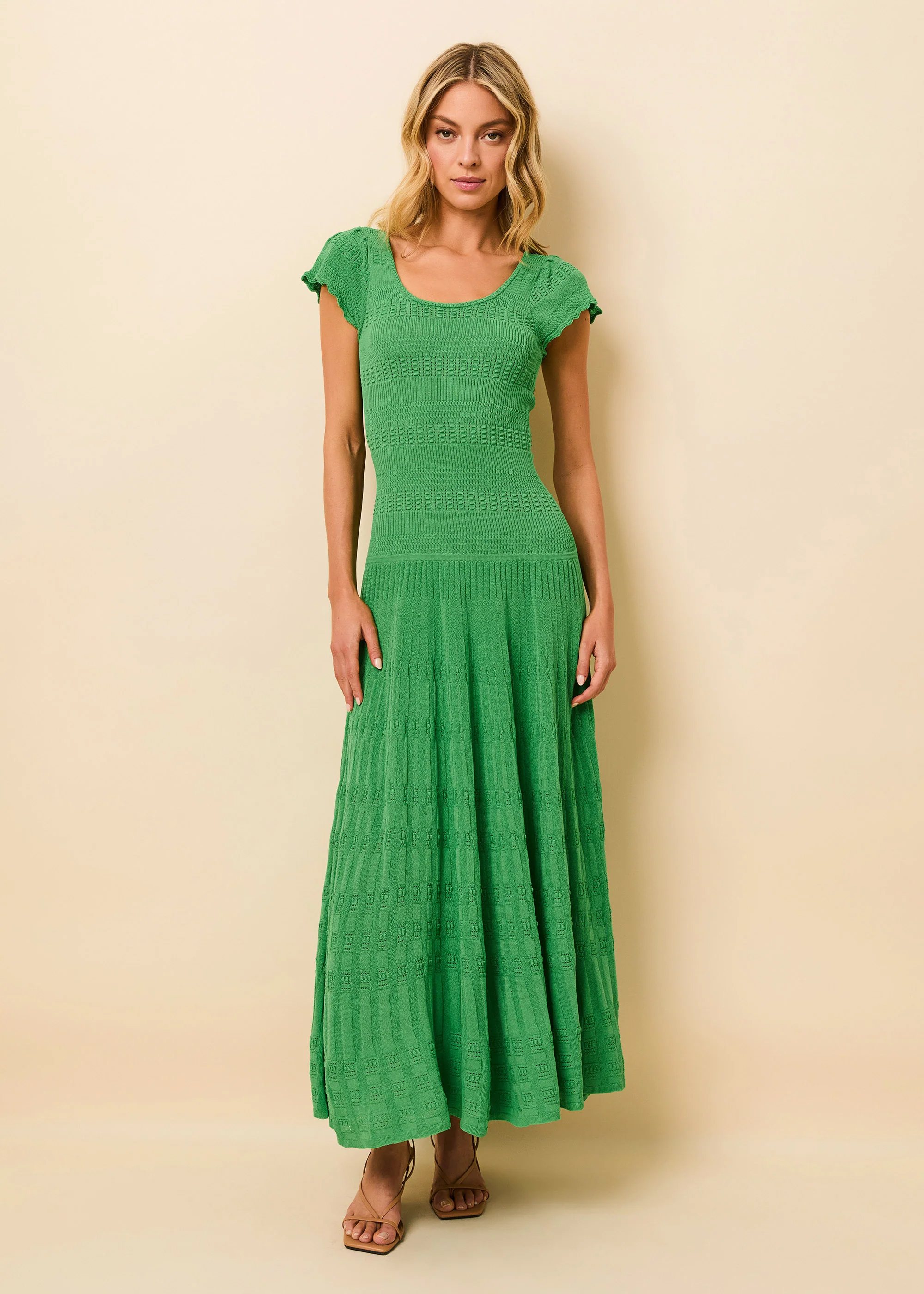 woman in pointelle knit green full length dress