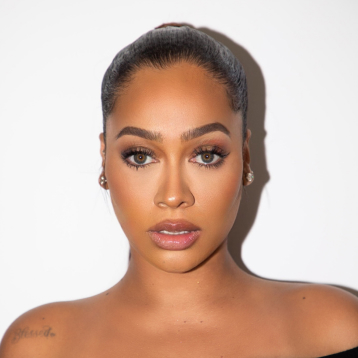 La La Anthony posing against a white background.