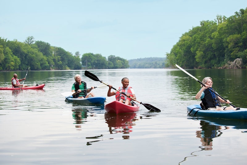 Couples kayaking on river