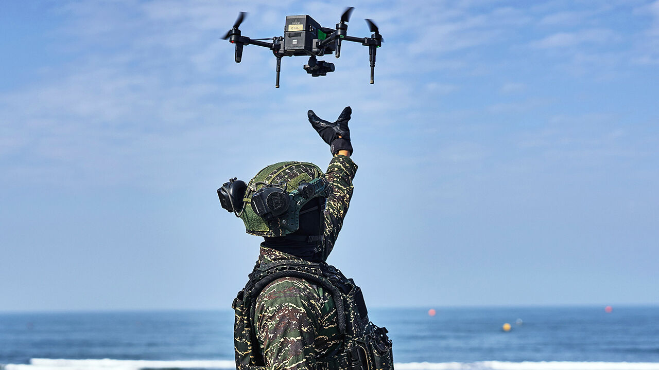 A solider releases a drone during a military exercise outside a naval base in Kaohsiung, Taiwan, on 29 January 2026.
