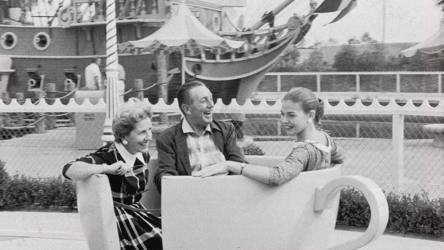 3 people ride the teacup ride.