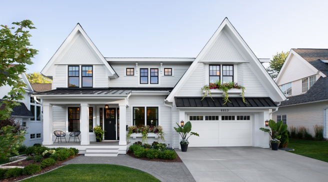Exterior view of a modern white farmhouse style home with a front porch.