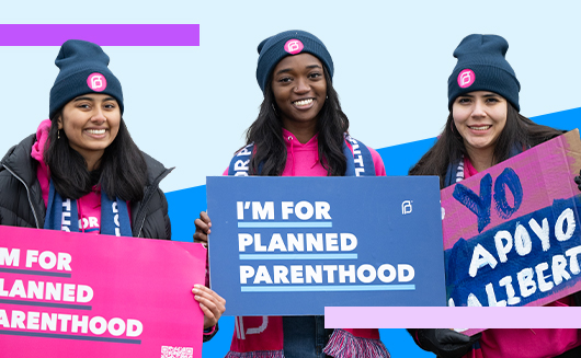 Supporters holding I'm For Planned Parenthood signs