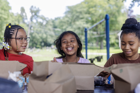 Jalissa, Aneah and Gianna, sitting at a table.

