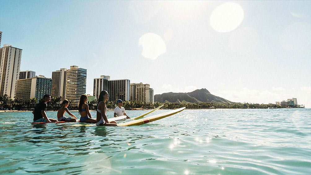 Image description: Surfing lessons at Waikiki Beach.
