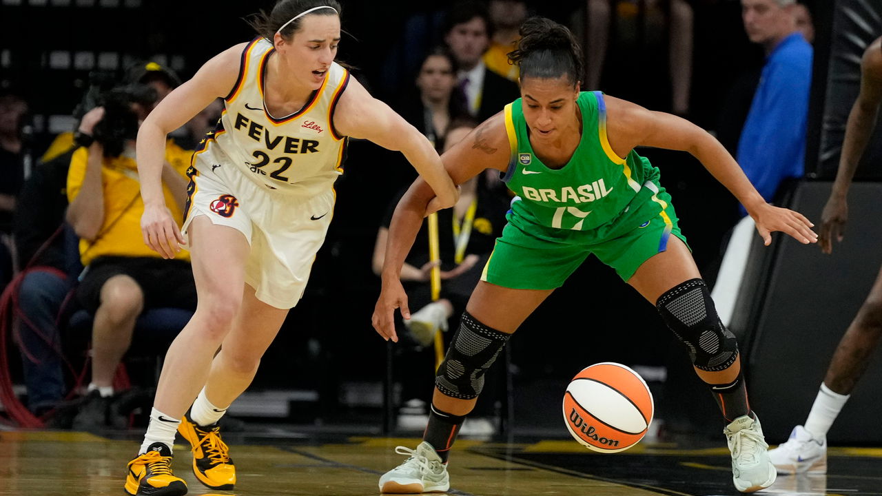 Indiana Fever guard Caitlin Clark fights for the ball with Brazil guard Carina Martins during an exhibition women's basketball game in Iowa City, Iowa, May 4th 2025