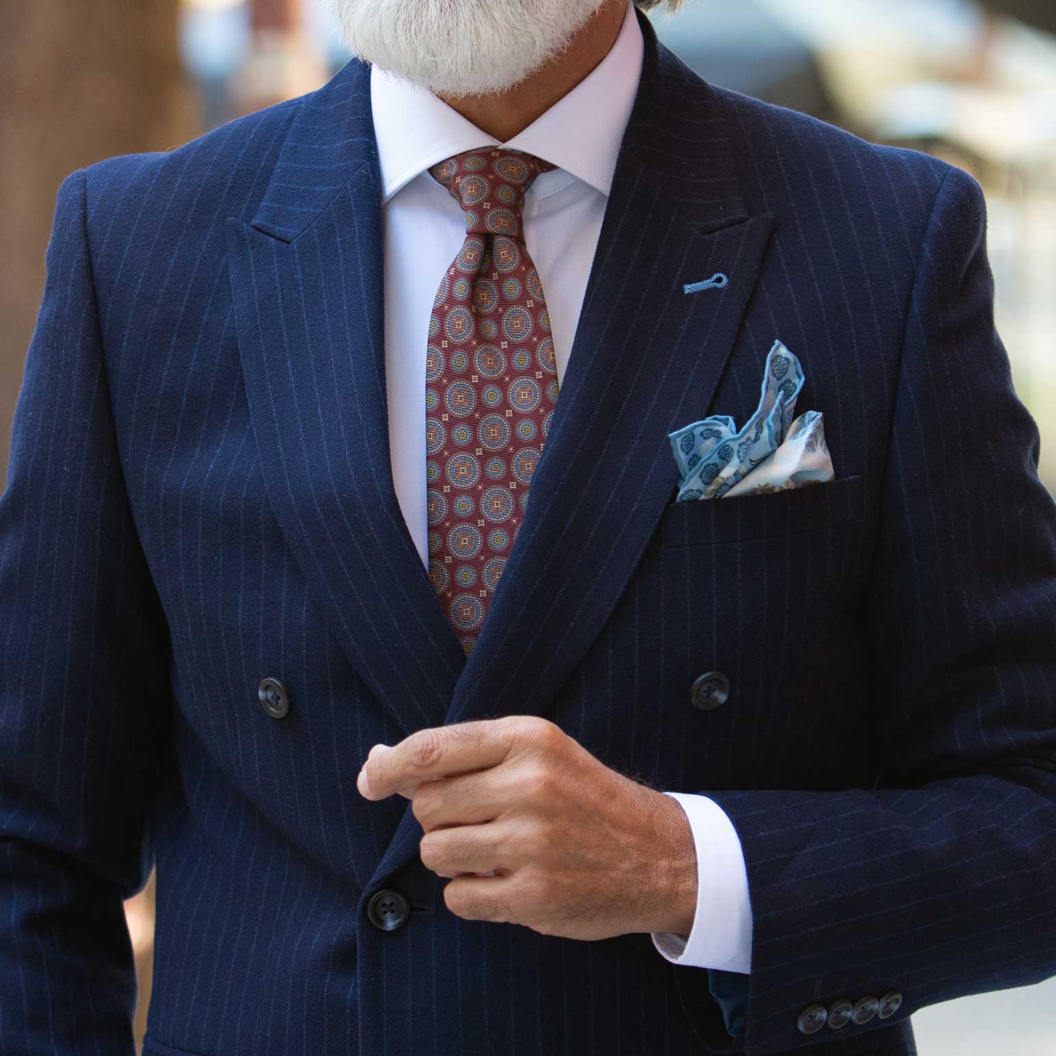 Red tie and blue and white silk pocket square