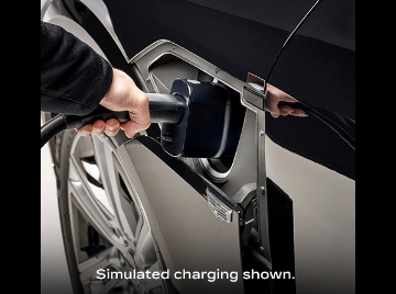 Charging cord being inserted with disclaimer “Simulated charging shown.”