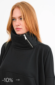 Emmy in The Boerum Sweatshirt featuring a side-zip collar.