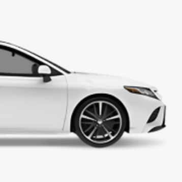 A side view of the front half of a white Toyota Camry on a light grey background.