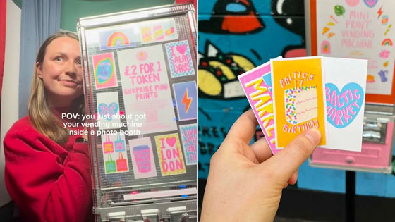 A woman holds her art and vending machine.