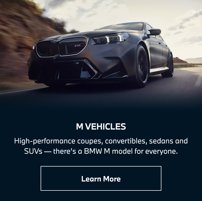 BMW M5 driving down the road. Learn more.