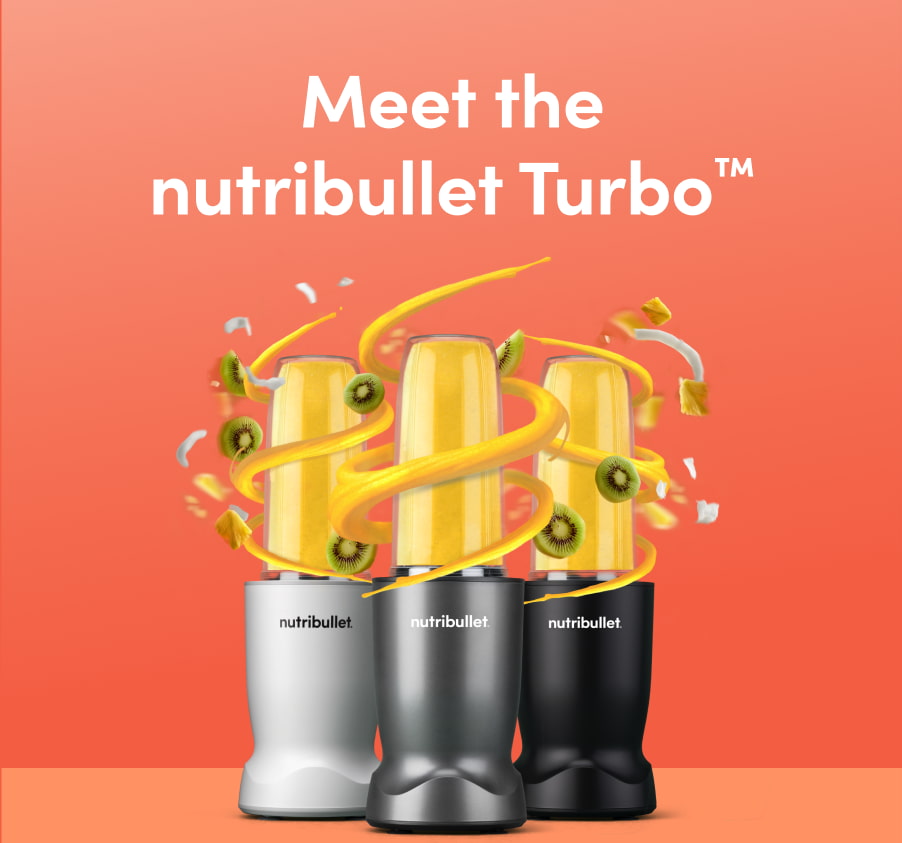 Three nutribullet blenders in white, silver, and black are displayed against a vibrant orange background. Each blender contains a bright yellow smoothie, with swirling ribbons of smoothie, kiwi slices, pineapple chunks, and coconut flakes flying around them, creating an energetic and tropical vibe.
