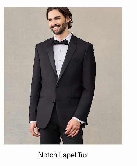 Smiling male model wearing a black Notch Lapel Tuxedo with a white dress shirt, black bow tie, and black pants. Text reads: "Notch Lapel Tux"