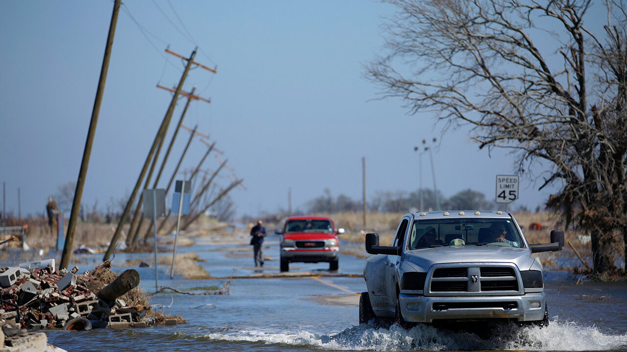 Residents drive through floodwaters after Hurricane Delta in Louisiana in 2020