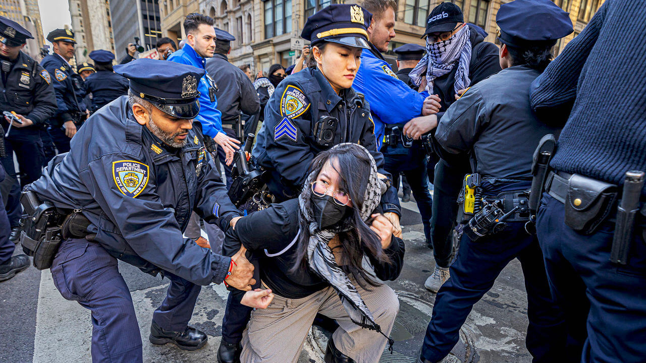  Policemen arrest student during students and pro-Palestine activists protest.