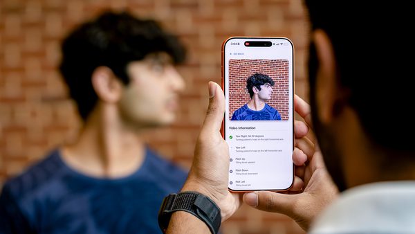 hands hold smartphone as it measures man's range of motion