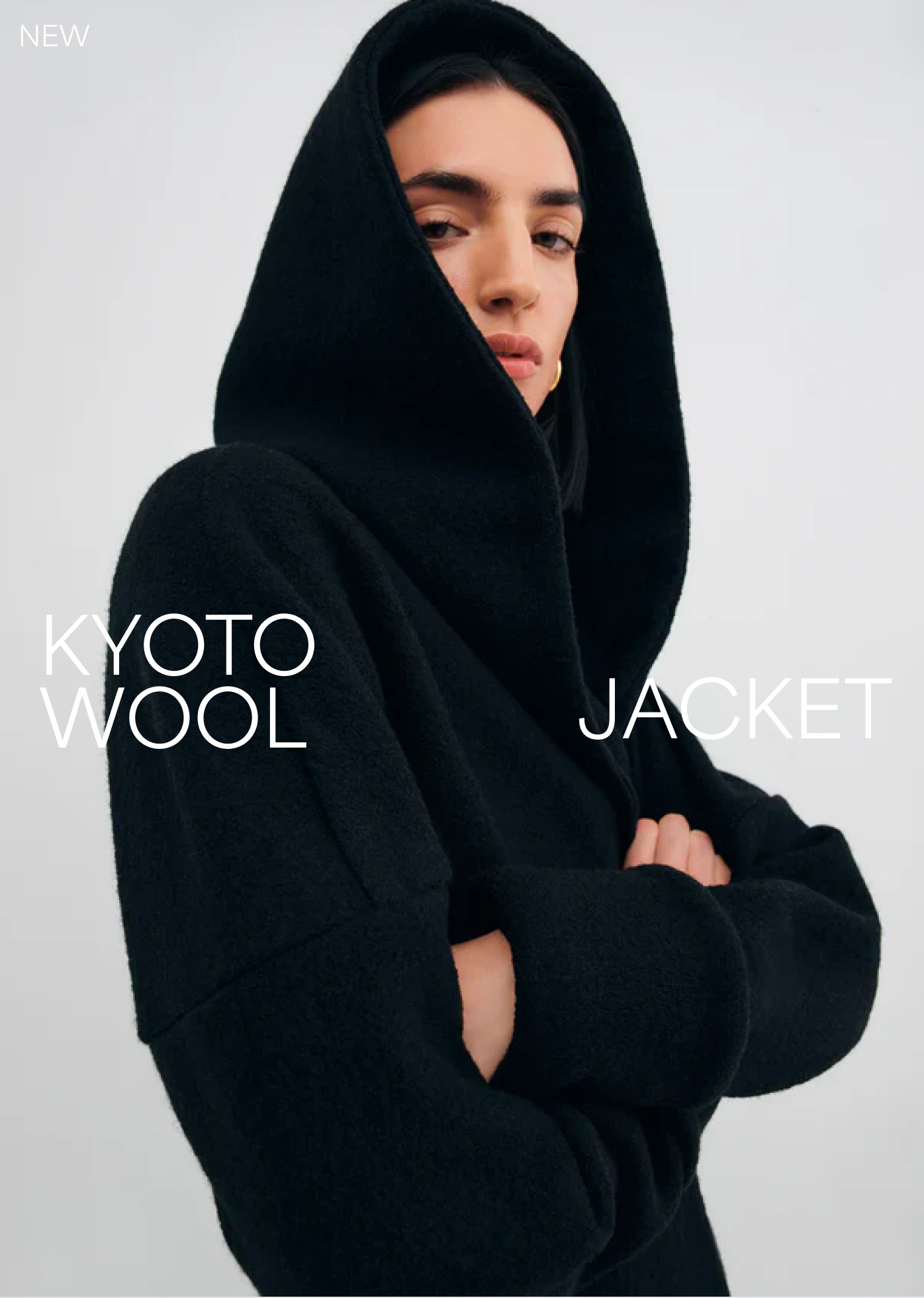 Emily in The Kyoto Wool Jacket poses with folded arms under the text “Kyoto Wool Jacket.”