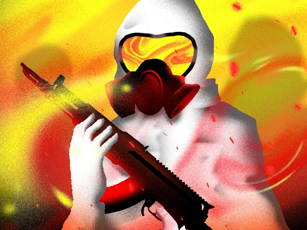 A person in a biohazard suit holds a gun.