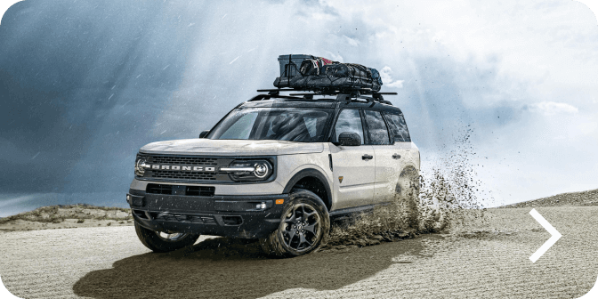A Bronco&reg; Sport SUV Badlands&reg; model being driven off road and kicking up dirt