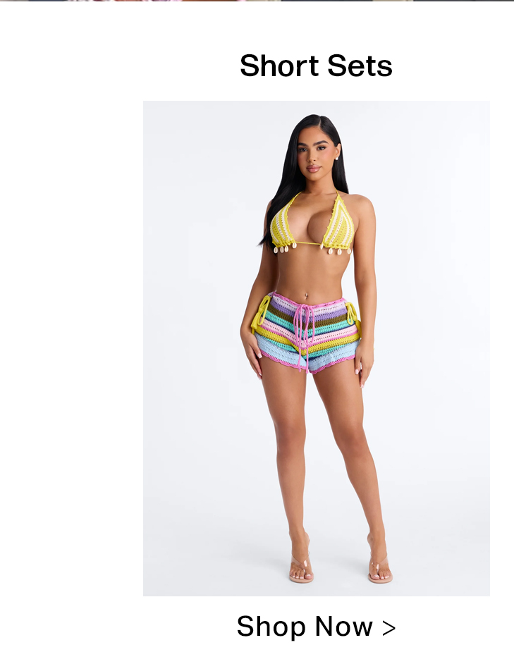 Woman in a yellow shell-embellished crochet bikini top and colorful pastel striped crochet shorts, highlighting our new short sets collection.