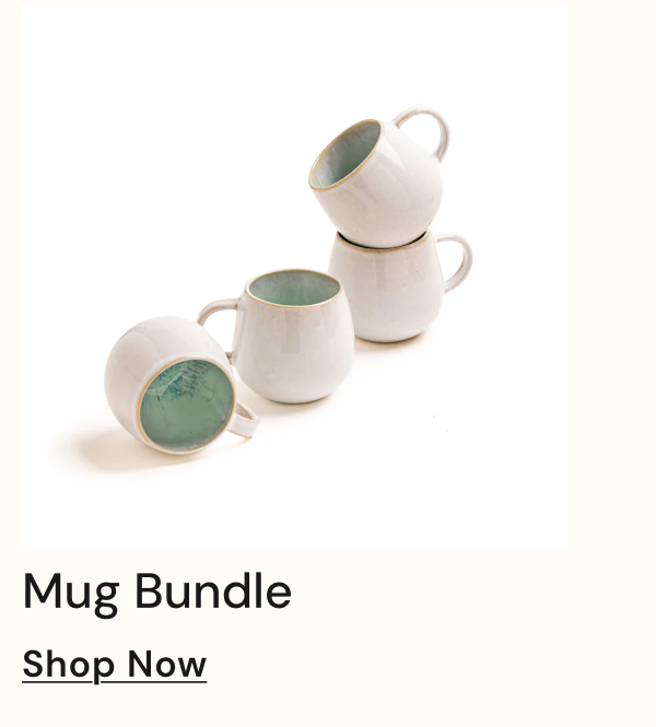 Four ceramic mugs stacked with a green interior.